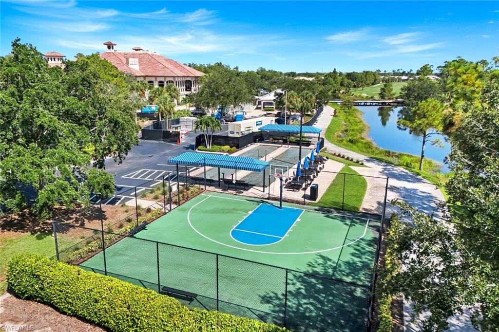Basketball court with integrated shaded seating, paved pathways, and a water feature