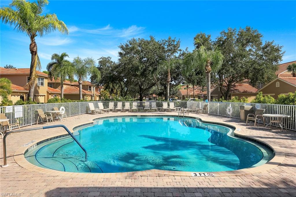 Sabal Palm Community Pool Surrounded by Tropical Landscaping