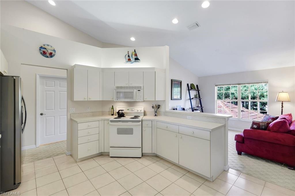 Bright Kitchen with Ample Counter Space and Open Den