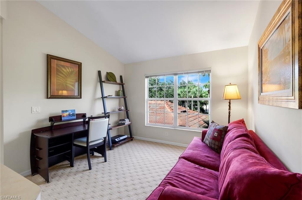 Versatile Open Den with Vaulted Ceiling, Workspace, and Abundant Natural Light