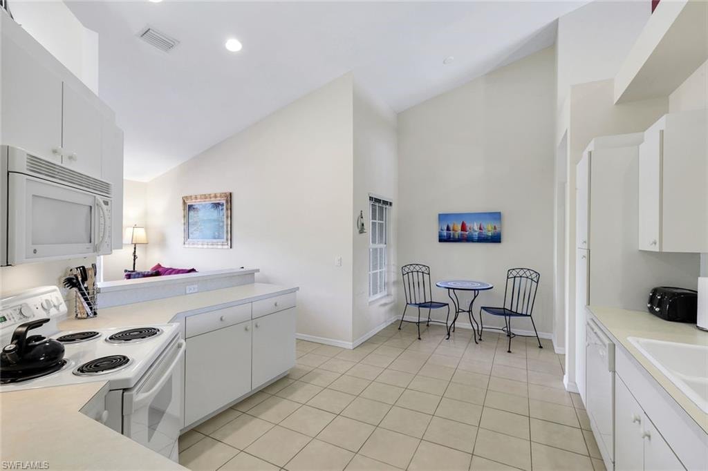 Open Kitchen with Vaulted Ceiling, Breakfast Bar, Breakfast Nook, and Ample Cabinetry