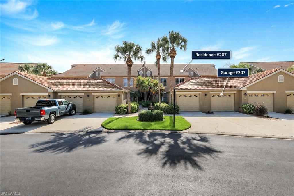 Exterior featuring multiple garage doors with carriage-style detailing, concrete driveways, and manicured landscaping with palm trees