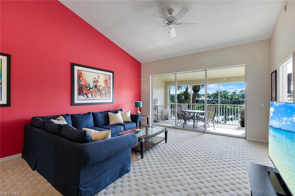 Spacious Great Room with Vaulted Ceiling, Ceiling Fan, and Sliding Glass Doors Opening to an East-Facing Screened Lanai