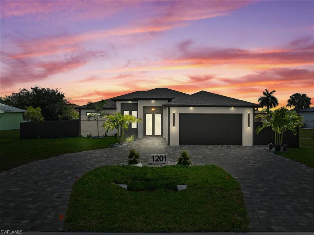 Contemporary-style residence featuring a dark-tiled roof and a paved driveway