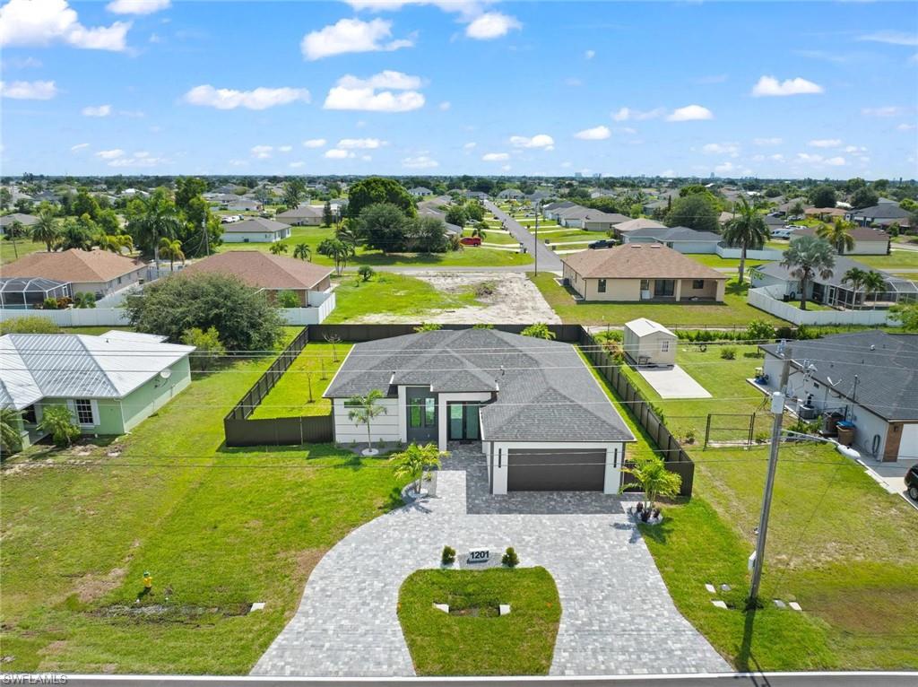 Contemporary exterior with a dark shingle roof, attached garage, and a paver driveway