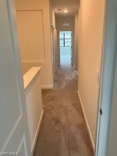 Hallway featuring carpet floors