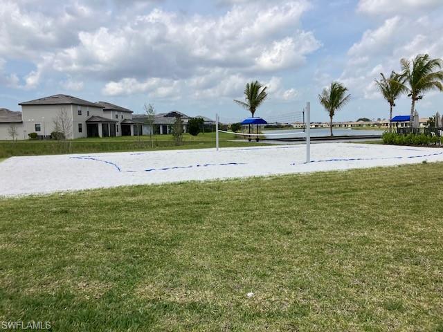 View of home's community featuring a lawn and volleyball court