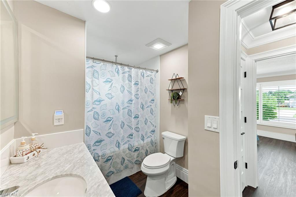 Bathroom featuring a vanity with a light-toned countertop, integrated sink, and white cabinetry
