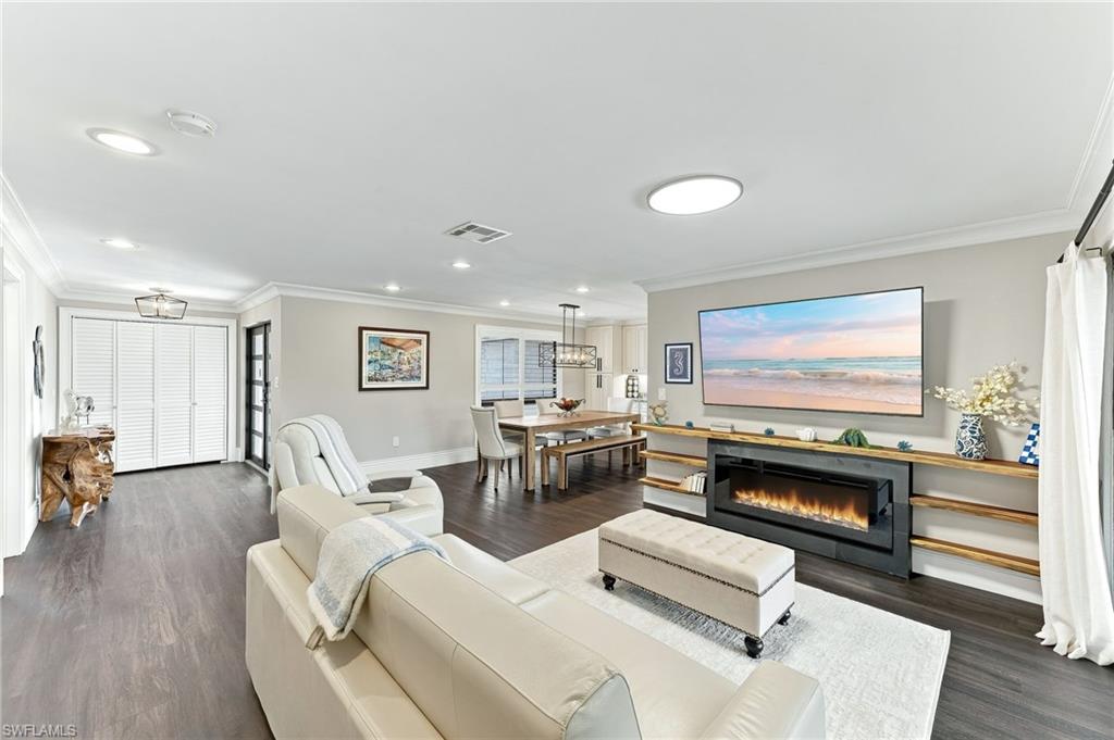 Spacious interior featuring wood-finish flooring, recessed lighting, and crown molding