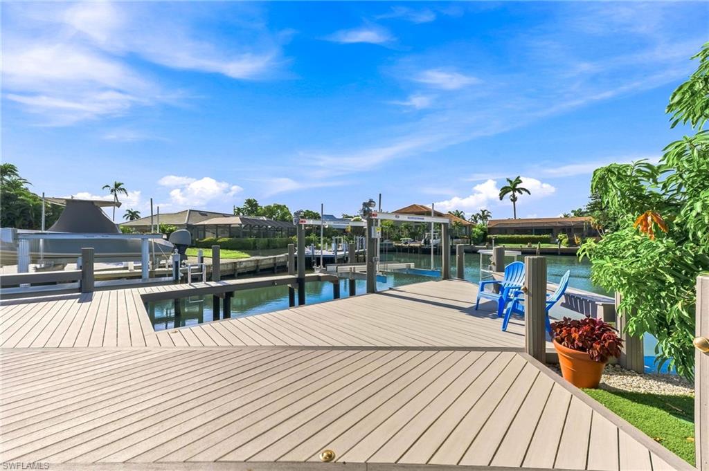 Composite wood decking with an integrated boat slip and boat lift, featuring waterfront access