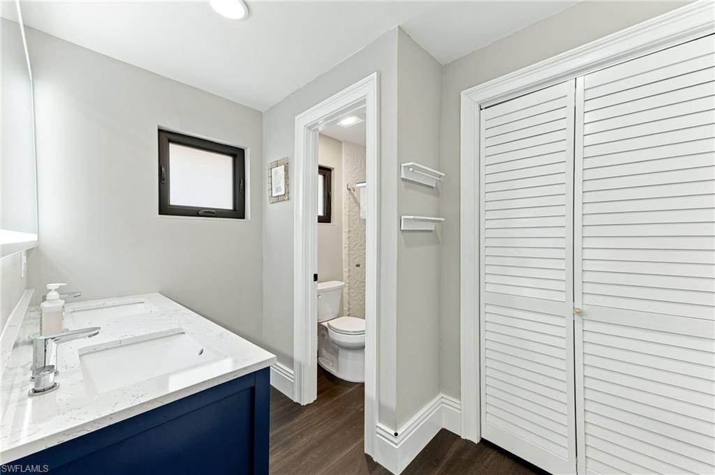 Dual vanity with integrated sinks, contemporary chrome faucets, and a dark blue vanity cabinet