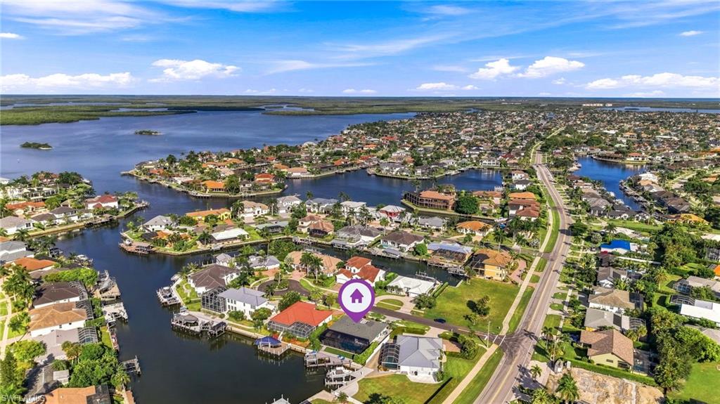 Aerial perspective featuring a waterfront property with a private dock