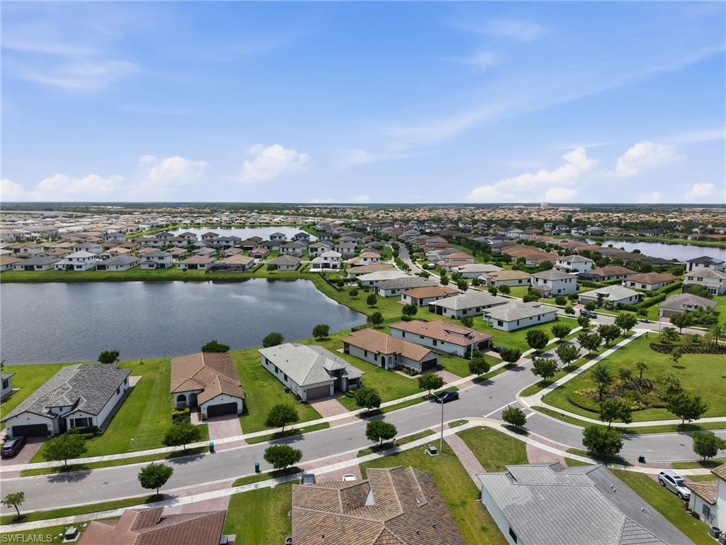 Aerial perspective showcasing a residential community with water features