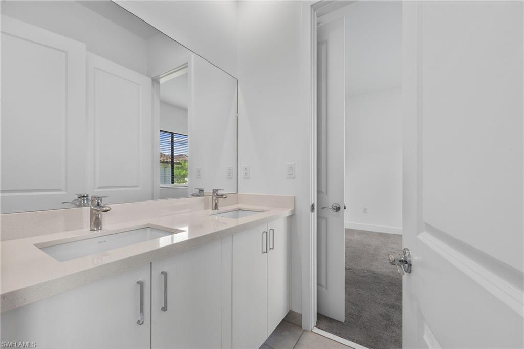 Dual integrated sinks with chrome faucets set into a light-toned countertop