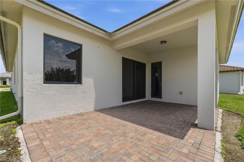 Covered patio featuring brick paver flooring