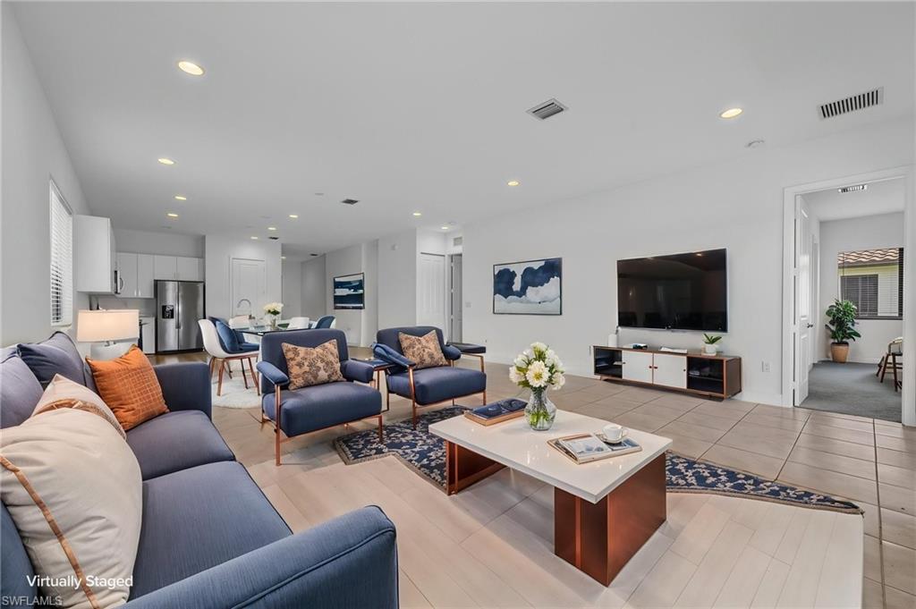 Open-concept living space featuring recessed lighting, tile flooring, and wood-finish flooring