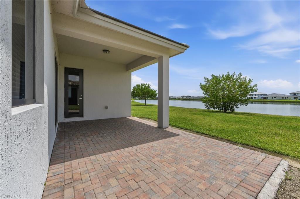 Covered patio featuring brick pavers