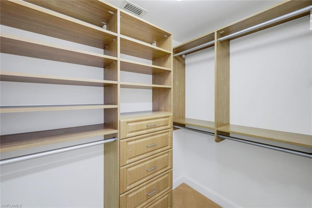 Primary bedroom has two walk-in closets with custom closet systems