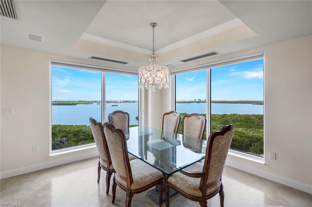 The dining area features a gorgeous chandelier and breathtaking views.