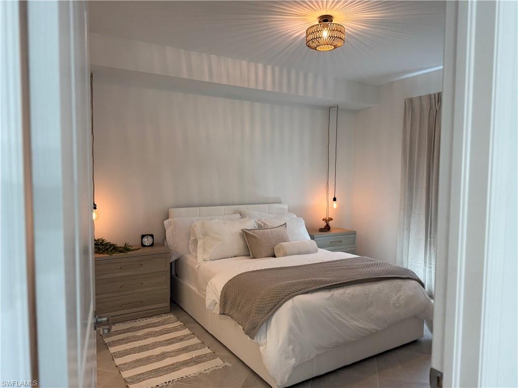 Recessed ceiling with a woven semi-flush mount light fixture, light gray wall color, light wood-finish nightstands, and a full-height window with drapes