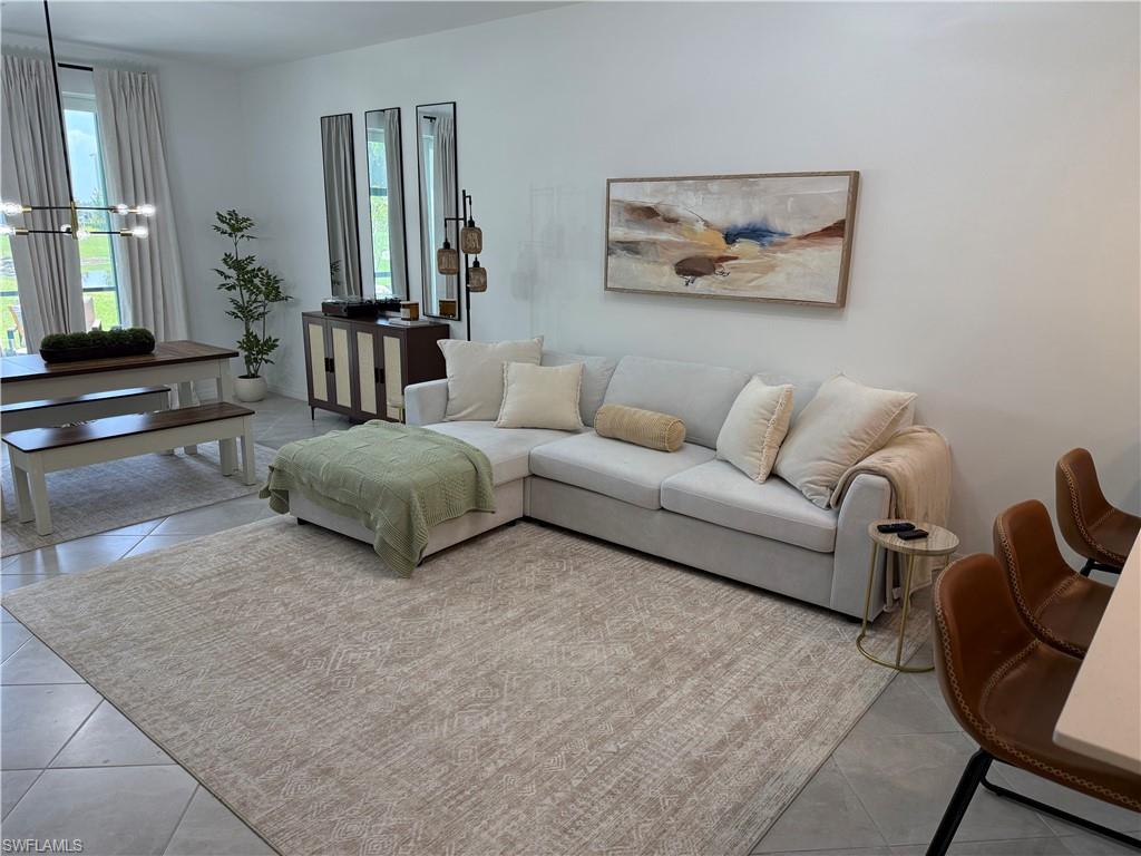 Open-concept living space with light-colored tile flooring