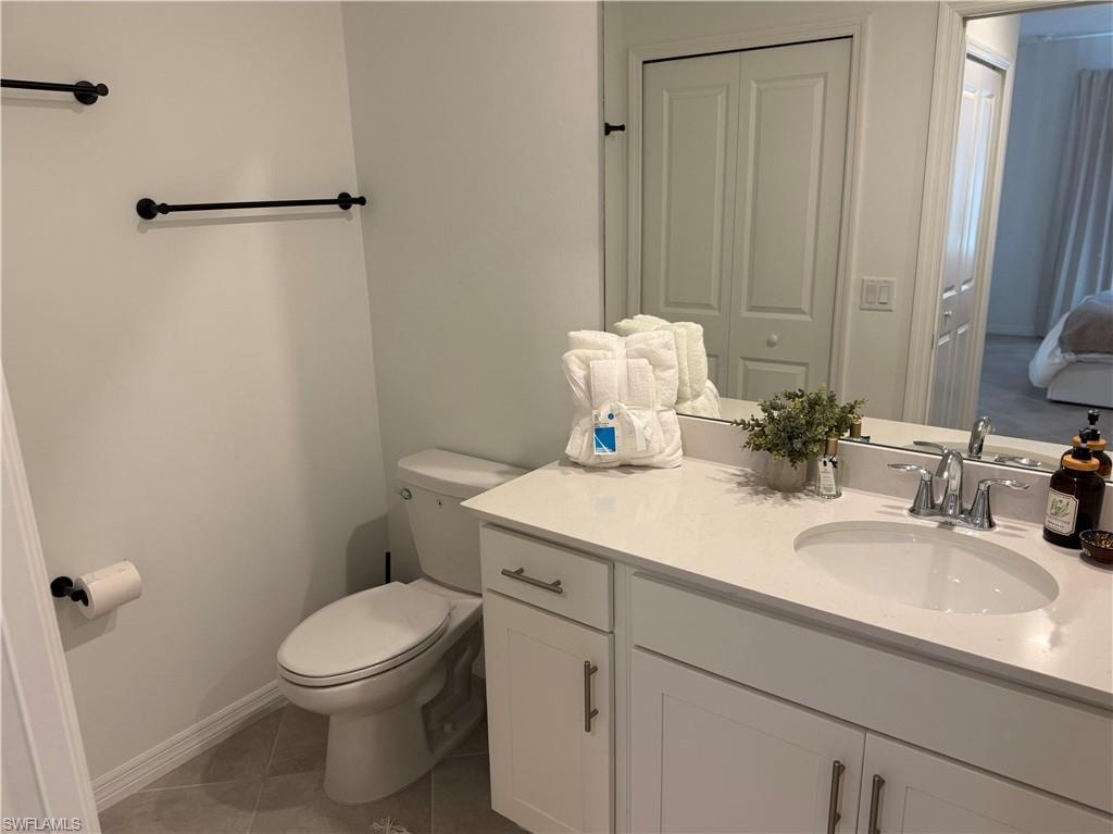 Vanity with an integrated sink, polished chrome faucet, and under-cabinet storage