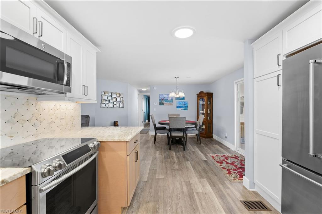 The open kitchen connects easily with the dining and living areas.