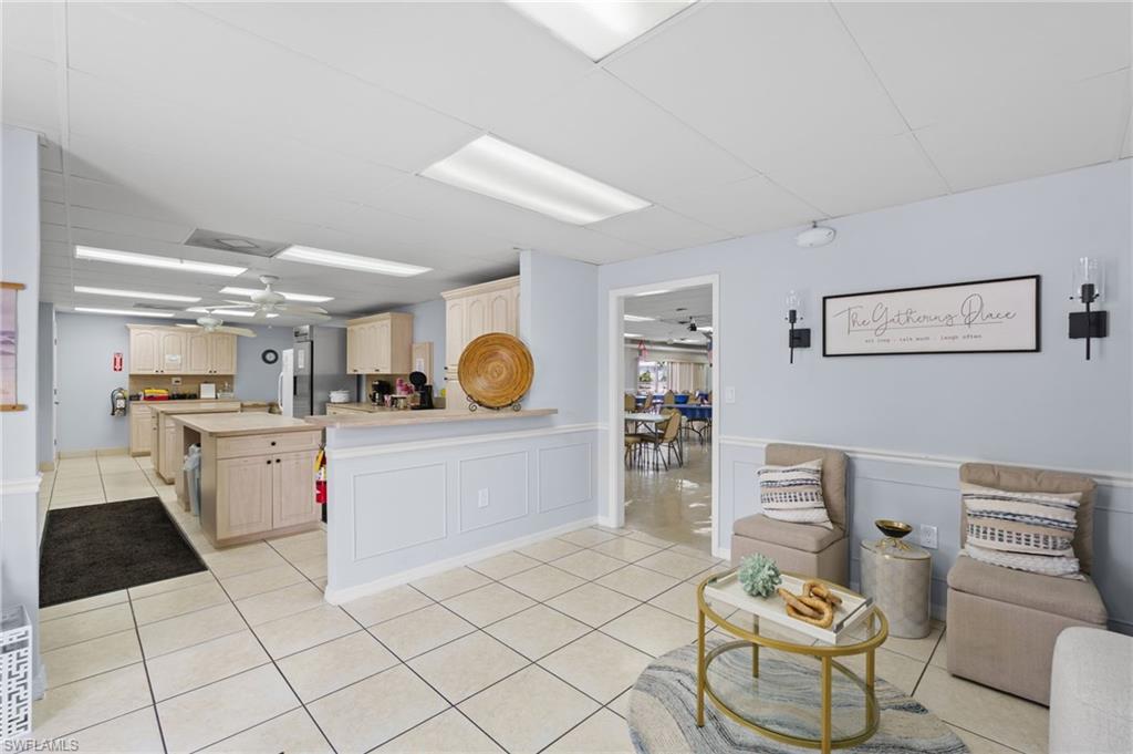 Community clubhouse gathering space with an adjoining kitchen.