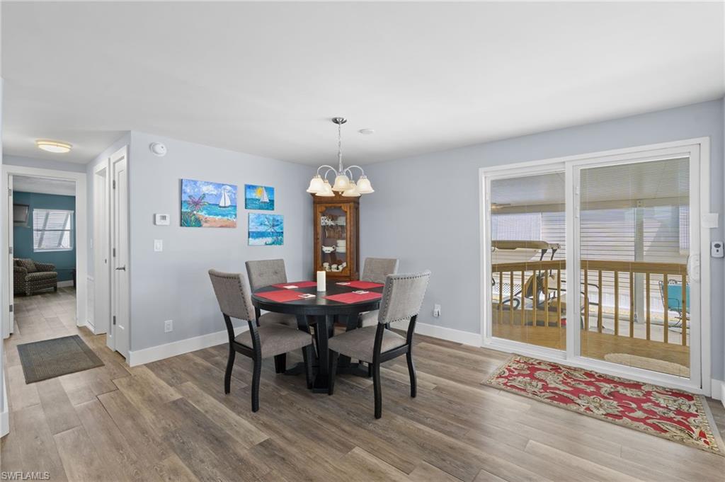 Dining area with wide-plank flooring.