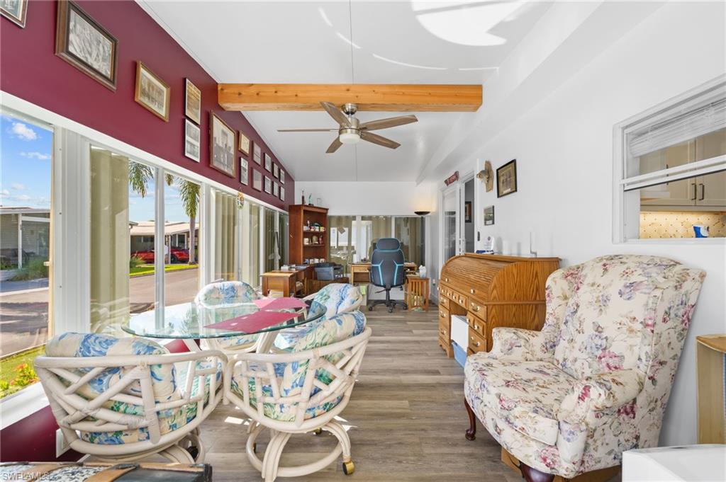 Window-lined Florida room/den offers flexible space for hobbies, cards or a home office.