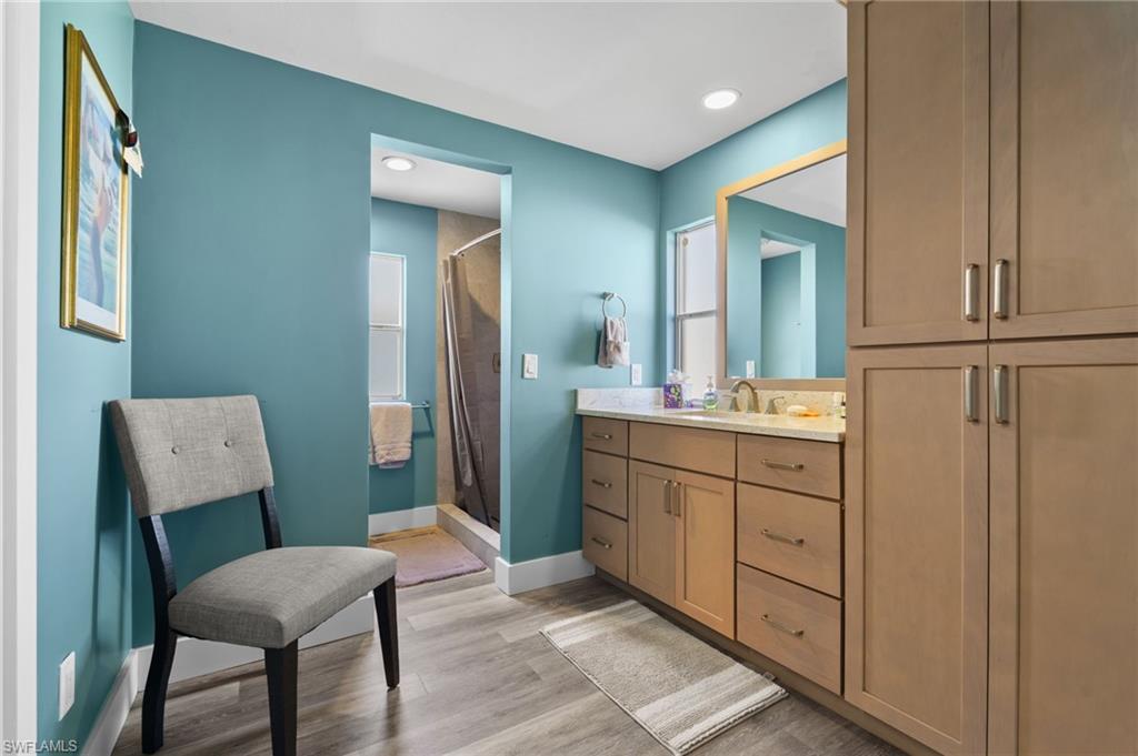 Updated primary bathroom with extensive cabinetry and storage.