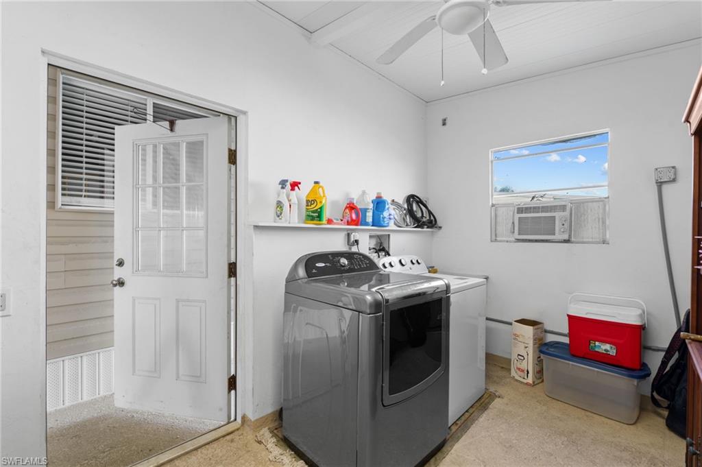 Leparate laundry and storage room located beneath the main roof.