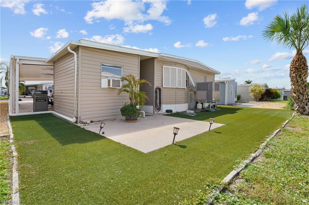 Rear patio and easy-care landscaping provide additional outdoor space.