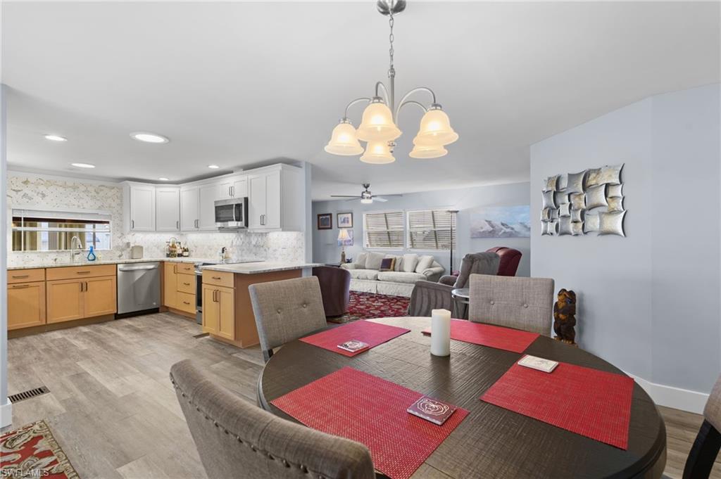 Open living and dining areas flow naturally into the remodeled kitchen.