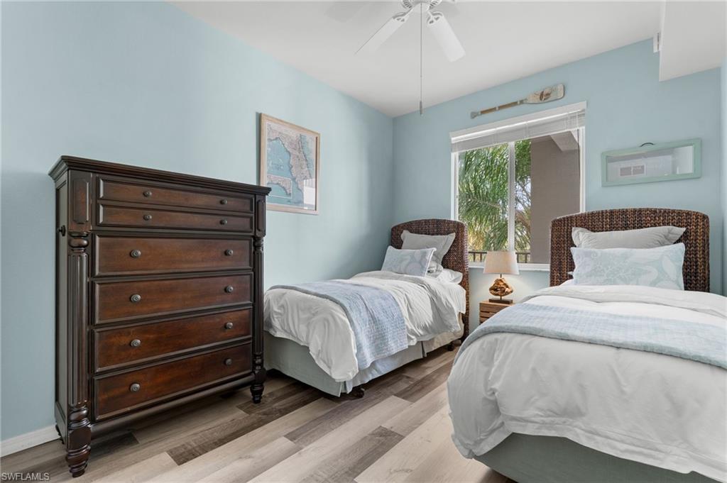 Wood-finish vinyl flooring, ceiling fan, and window with blinds