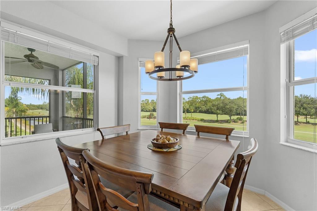 Bay window area with multiple windows, a bronze-finish chandelier, and tile flooring