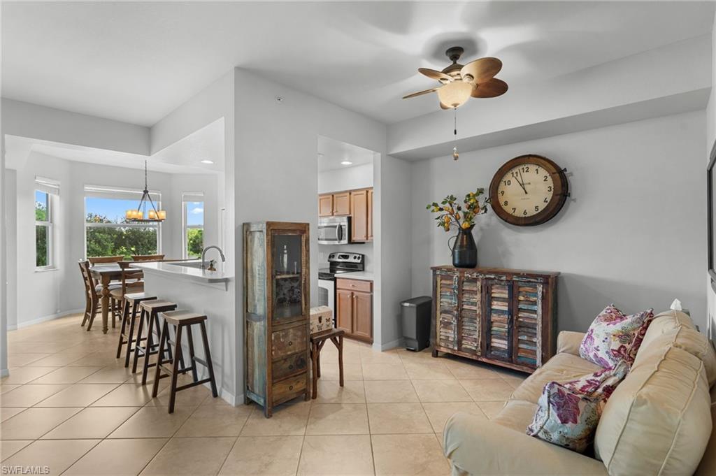 Open-concept room featuring neutral paint, tiled flooring, recessed lighting, and a ceiling fan