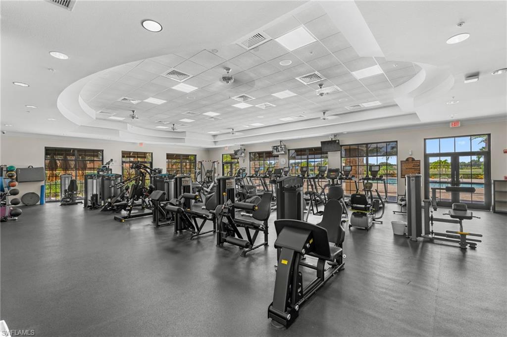 Spacious fitness center featuring various exercise equipment and lots of natural light