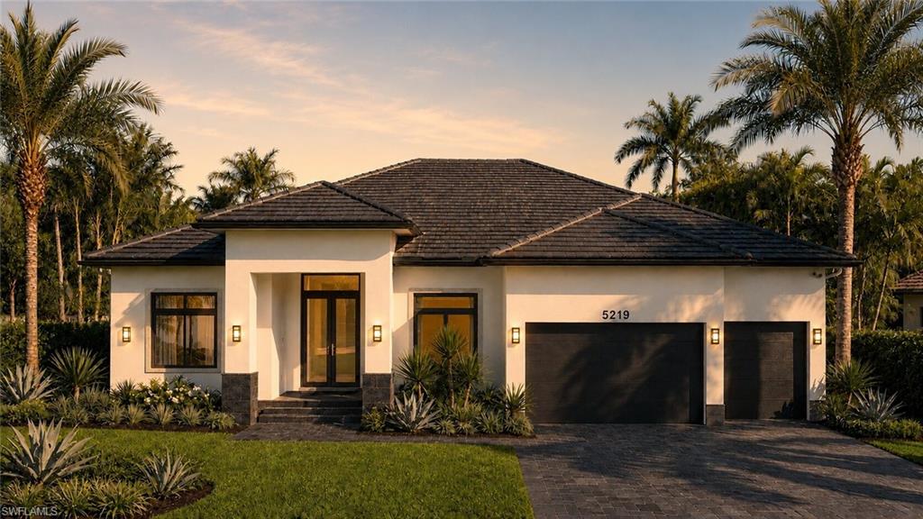 (Rendered photo) Modern stucco facade with a dark tile roof, paved driveway, two garage doors, and front entry with double glass doors