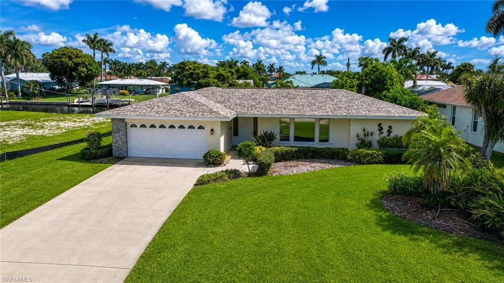 Manicured front lawn with mature landscaping