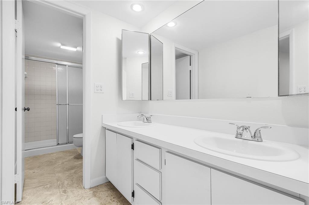 New dual sinks and simple white cabinets in the master bathroom. Dual medicine cabinets are functional and pretty.