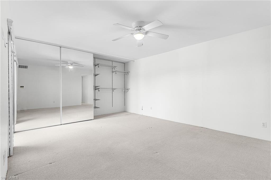Master Bedroom has quad mirrored sliding doors - these are halfway open to show the ample storage behind .