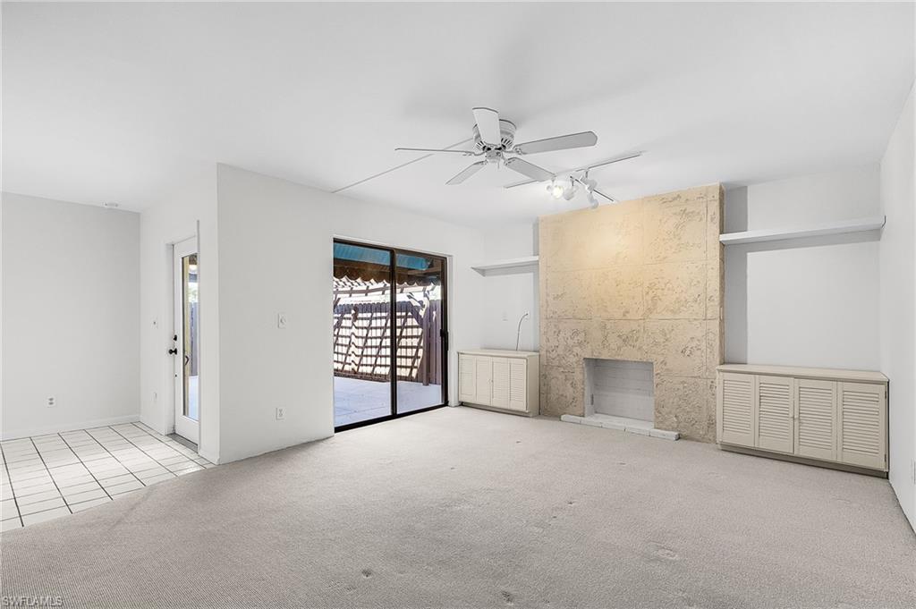 Hurricane rated full glass front door, sliding doors, a peek out to the patio and the faux stone finished 'fireplace'. Built in storage w/louvered doors.