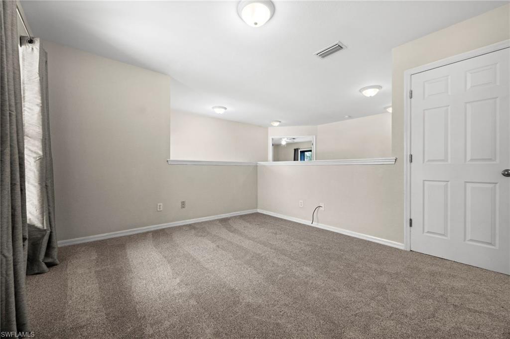 Second view of the upstairs loft highlights the open railing and connection to surrounding bedrooms and hallway. The flexible bonus area expands the home's usable living space without sacrificing bedroom privacy.
