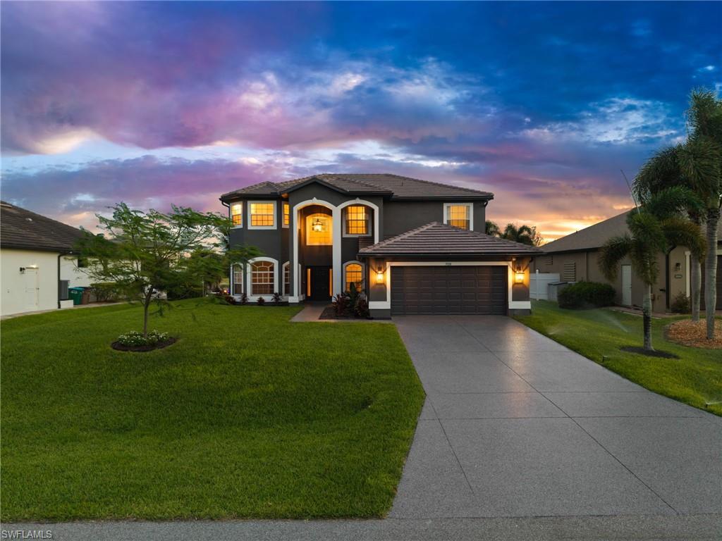Private screened upper-level balcony overlooking the waterfront neighborhood, offering a peaceful outdoor retreat with palm-lined views and colorful Southwest Florida skies. This elevated outdoor space adds another place to relax while enjoying the canal-side setting.