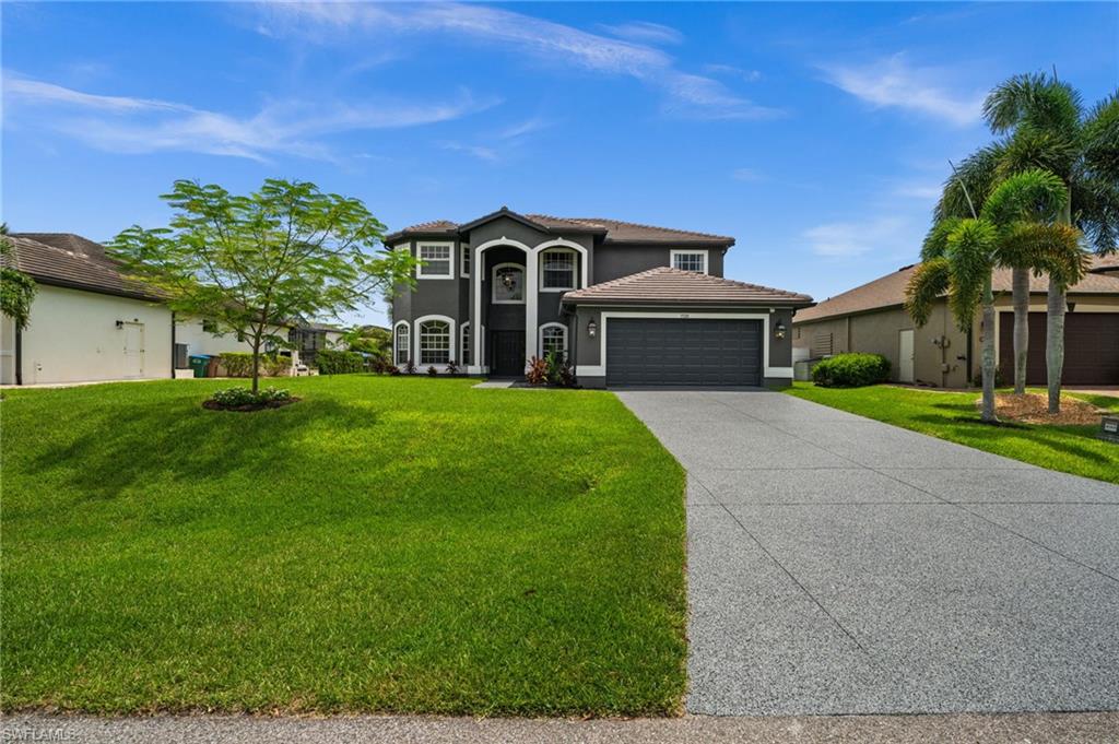 Daytime exterior highlights the home's fresh landscaping, wide driveway, two-story design, and updated exterior presentation. Improvements documented for the property include the tile roof, exterior paint, turf overhaul, and refreshed landscape beds.