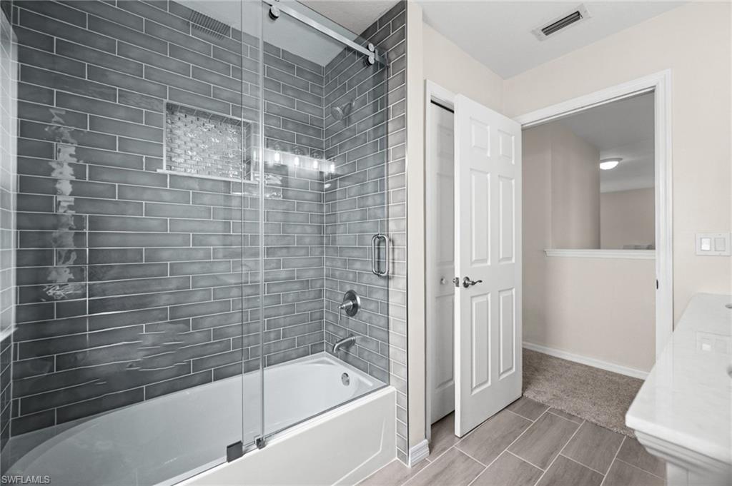 Additional upstairs bedroom features carpeting, ceiling fan, natural light, and closet storage. The flexible space can accommodate a guest bedroom, family member, or dedicated home office.