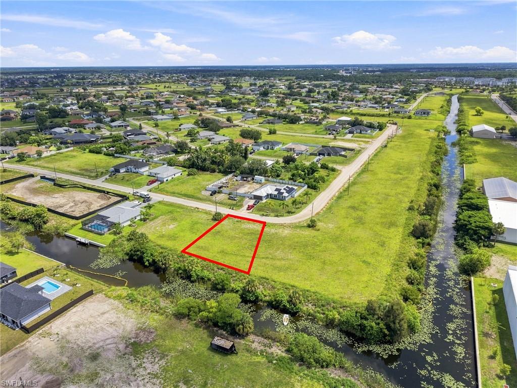 Expansive grassy lot bordered by a canal