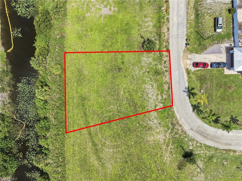 Grassed lot with canal frontage, positioned near a paved road