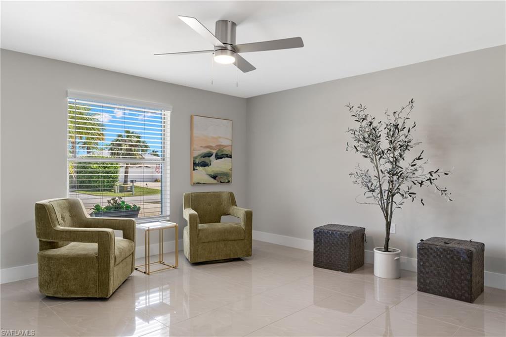 Living area featuring tile flooring and ceiling fan